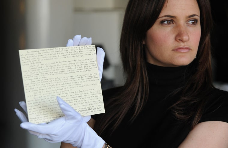 A Waterstones staff member holds a story written by JK Rowling donated by the author, for the What's Your Story? auction in aid of English PEN and Dyslexia Action, in London on June 10, 2008.