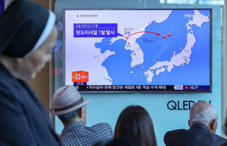 Image: People watch a news report on North Korea firing a ballistic missile, at a railway station in Seoul