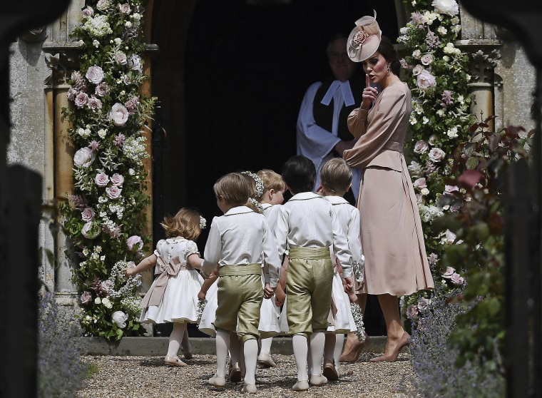 Duchess of Cambridge gestures as she walks with the bridesmaids and pageboys as they arrive for her sister Pippa Middleton's wedding to James Matthews, at St Mark's Church in Englefield, England, Saturday, May 20, 2017.