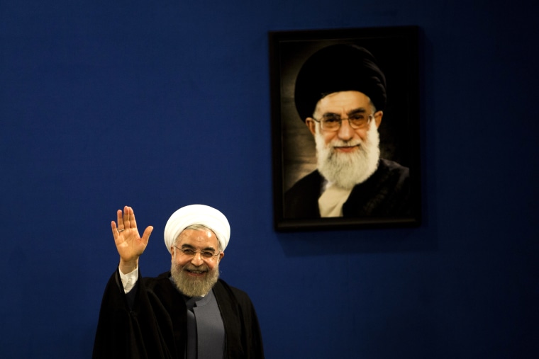 Image: Iranian President Hassan Rouhani next to a portrait of Ayatollah Ali Khamenei in 2015