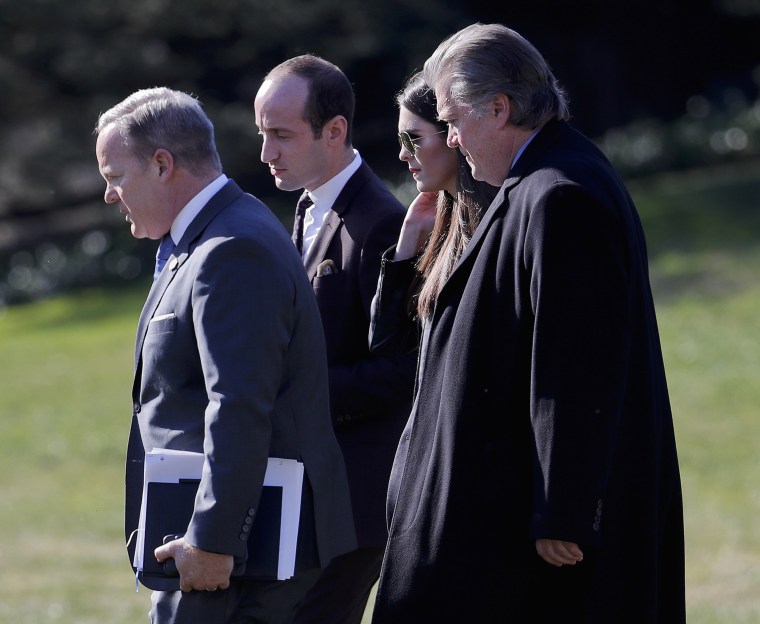 Image: Spicer, Miller, Hicks, and Bannon walk across the South Lawn of the White House