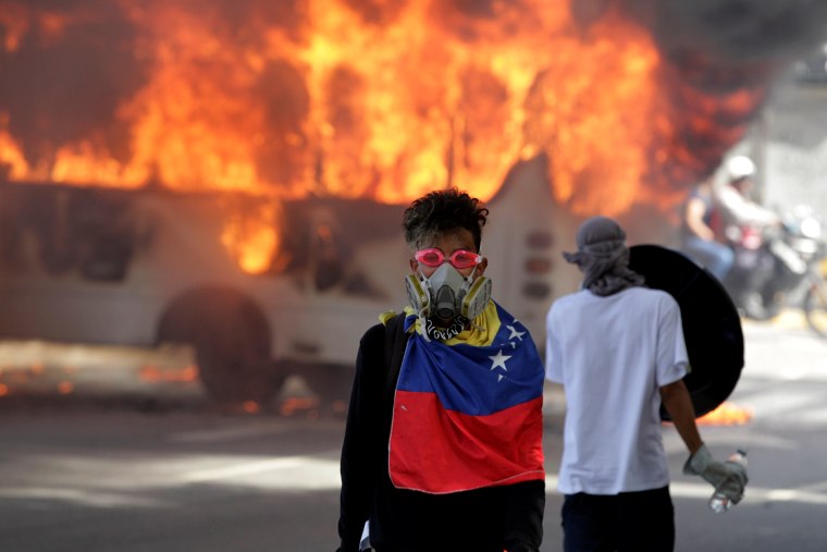 Image: Fiery protests in Caracas were among many across Venezuela on Monday.