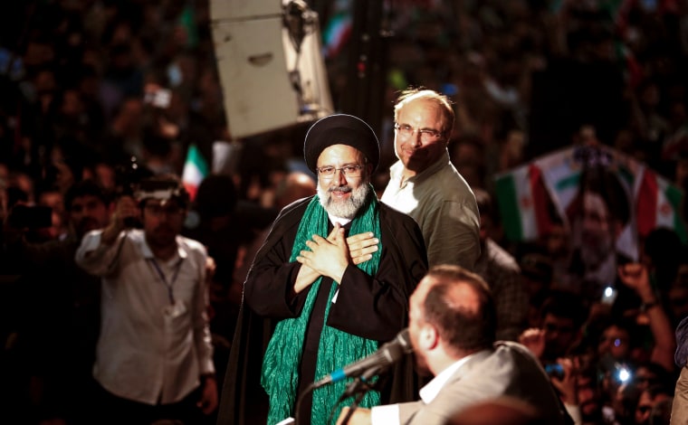 Image: Iranian presidential candidate Ebrahim Raisi (C) greets his supporters as he stands with former presidential candidate and mayor of Tehran