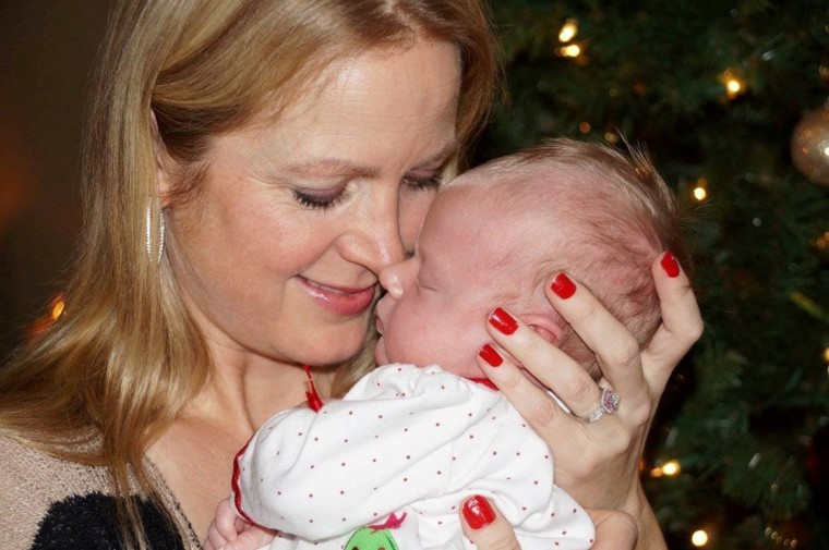 Image: Frontier Airlines flight attendant Jo Roby holds her baby