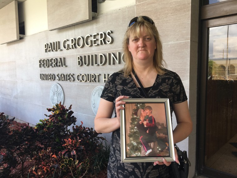 Image: Sandy Hinkle holds a photo of her daughter Kaitlyn Cruea