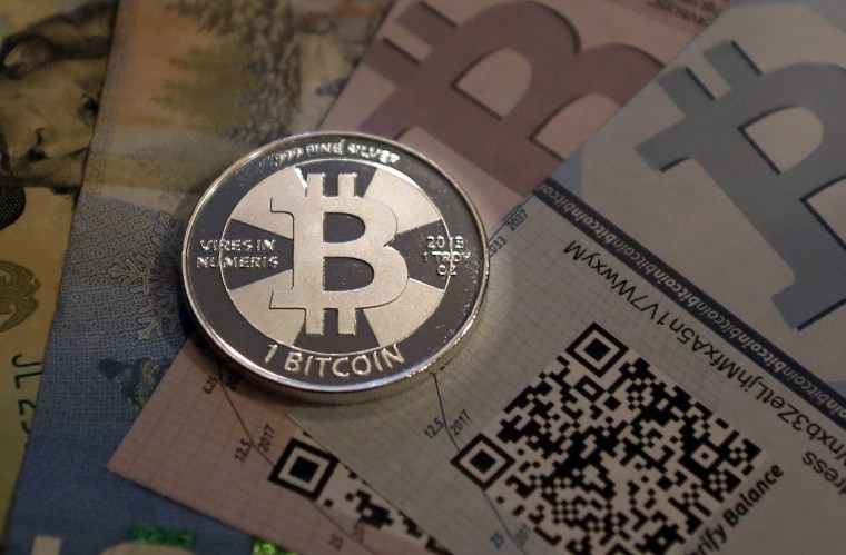 Image: One of Bitcoin enthusiast Mike Caldwell's coins in this photo illustration at his office in Sandy