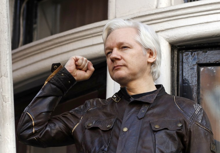 Image: Julian Assange greets supporters outside the Ecuadorian embassy in London