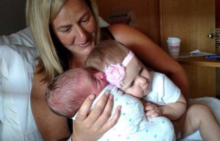 Sarah Traupman with her children after the birth of the couple's son, Cooper.