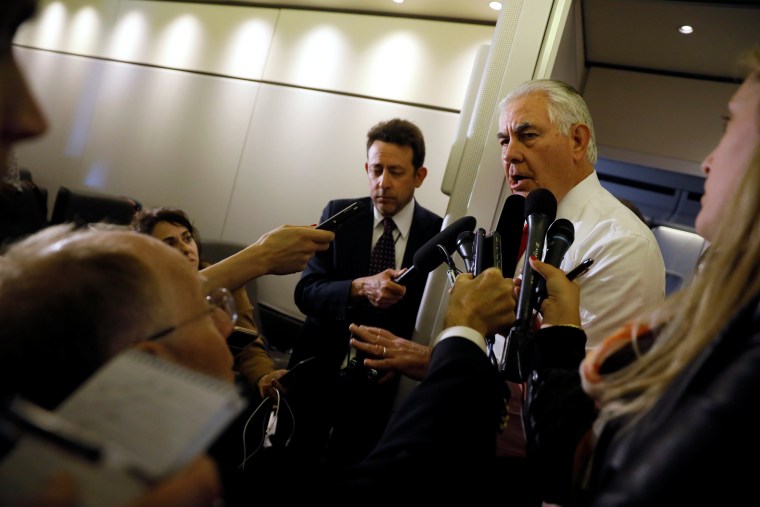 Image: Rex Tillerson speaks with reporters aboard Air Force One