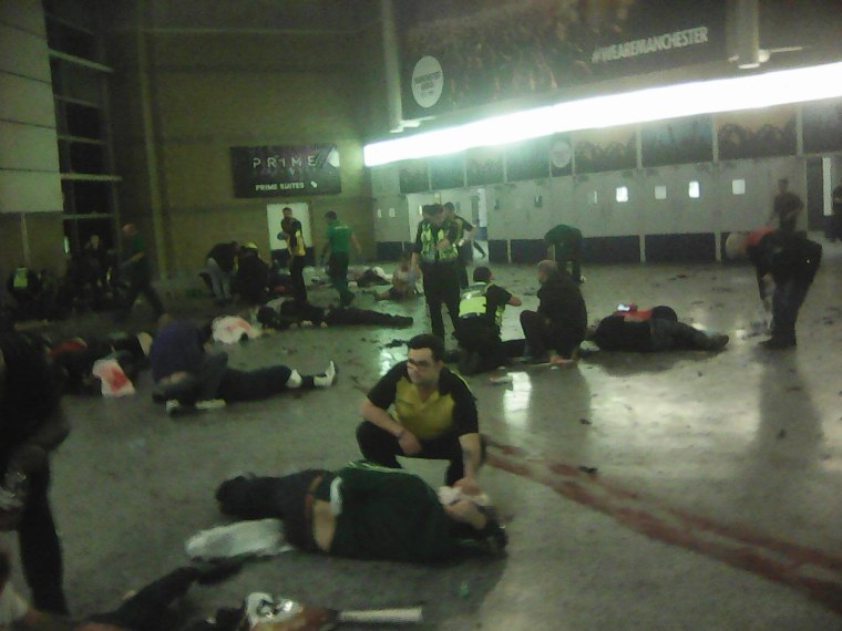 Image: Helpers attend to people inside the Manchester Arena after a suspected suicide bomber detonated an explosive device