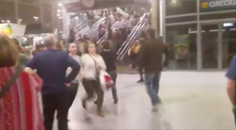Image: People running down stairs as they attempt to exit the Manchester Arena after a blast on Monday