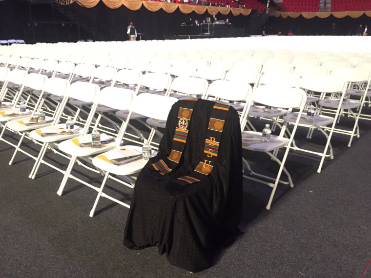 Image: A gown rests on a seat in honor of Lt. Richard Collins III at the Bowie State University graduation