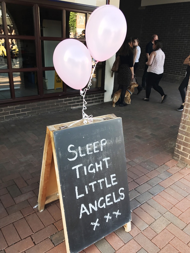 Image: A sign at the vigil in Tarleton, England reads "Sleep tight little Angels"