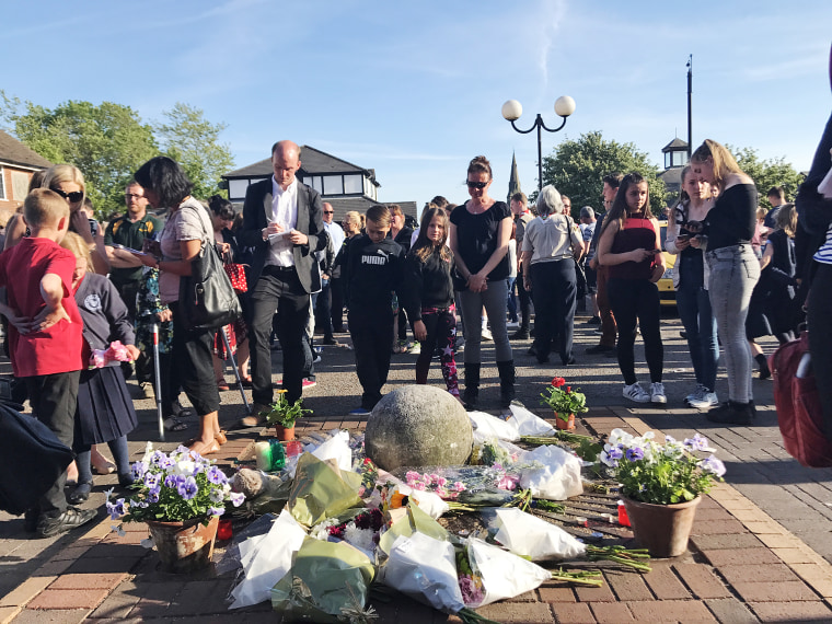 Image: Locals gather in Tarleton, England for a vigil