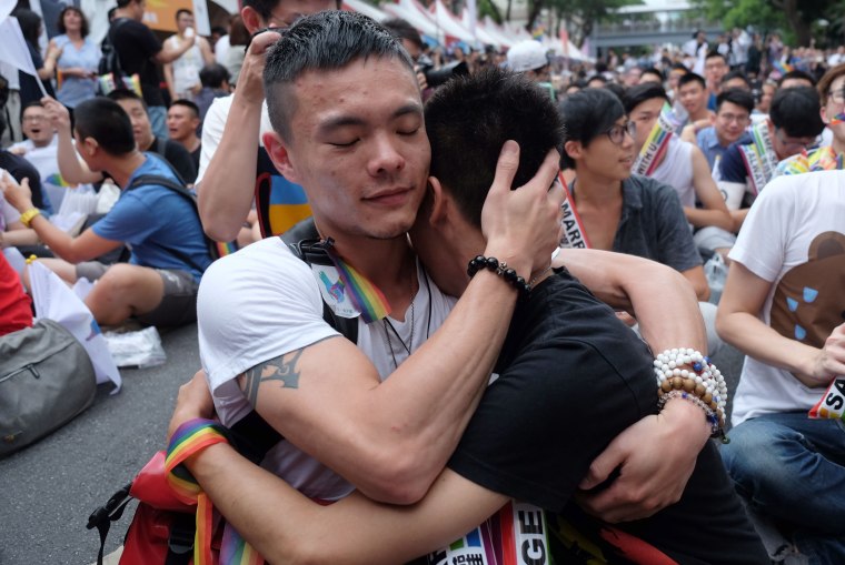Image: Crowds hugged and wept outside the parliament in Taipei after Taiwan's gay marriage ruling.