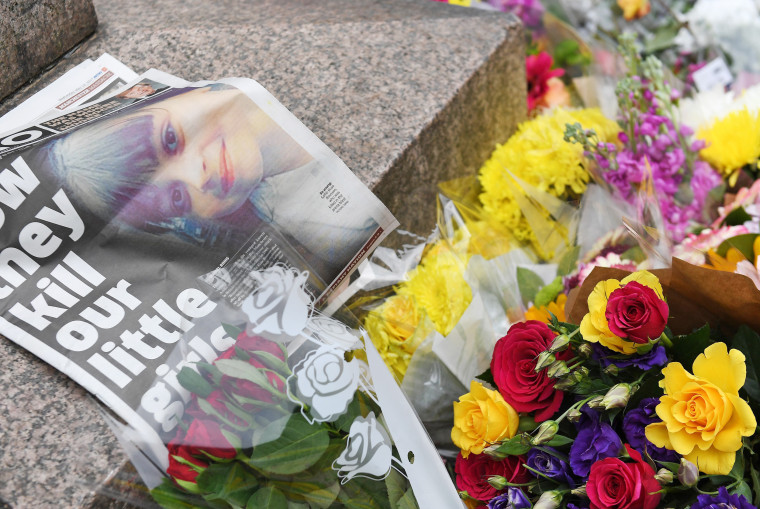 Image: Flowers and a newspaper at a vigil in Manchester
