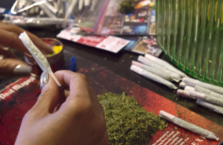 Image: A member of the D.C. Marijuana Coalition prepares joints