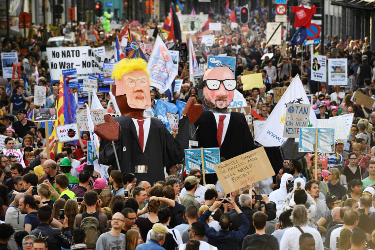 Image: People carry effigies of US President Donald Trump (L) and Belgian Prime Minister Charles Michel during a demonstration