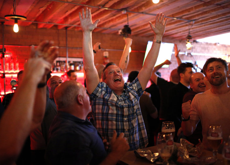 Image: Manchester United fans celebrate the second score of their team during the Europa League final against Ajax Amsterdam in a pub in Manchester