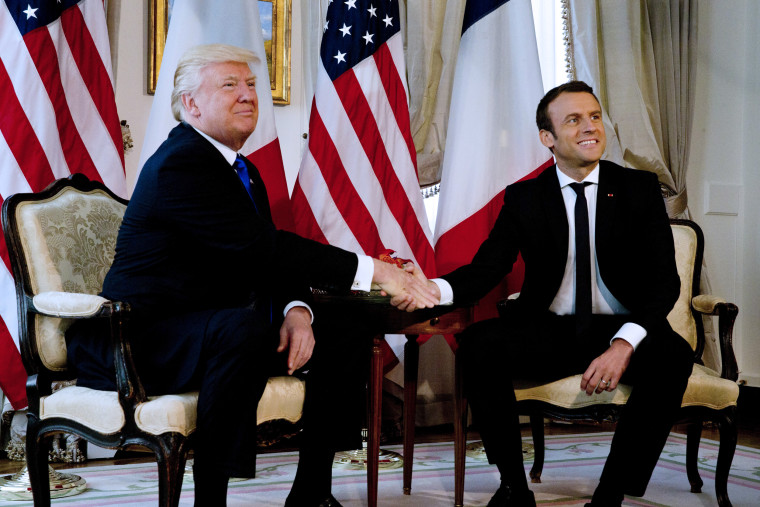 Image: President Donald Trump shakes hands with French President Emmanuel Macron in Brussels