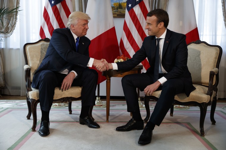 Image: President Donald Trump shakes hands with French President Emmanuel Macron in Brussels
