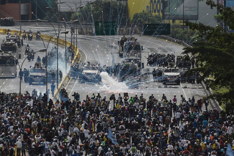 Image: Riot police clash with opposition demonstrators during a protest in Caracas