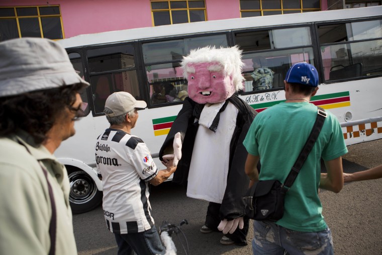 In this May 19, 2017 photo, a performer dressed as presidential hopeful Andres Manuel Lopez Obrador shakes hands with supporters after a campaign rally for Delfina Gomez, who's running for governor of Mexico state with Obrador's party, the National Regeneration Movement, or Morena, in Ecatepec, Mexico state, Mexico.