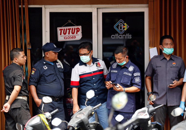 Image: FILE PHOTO: Police and security are seen outside the club where police detained 141 men for what they described as a gay prostitution ring in Jakarta