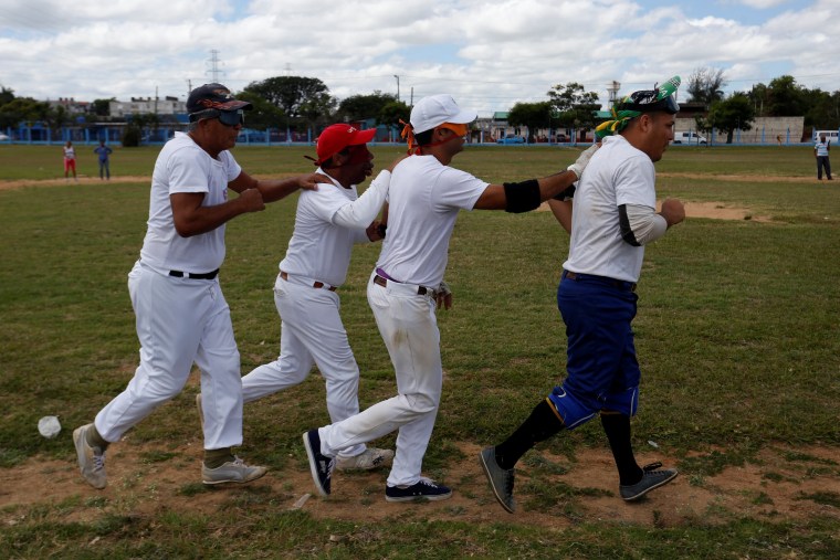 Image: The visually impaired warm up during a baseball lesson at the  Changa Medero stadium