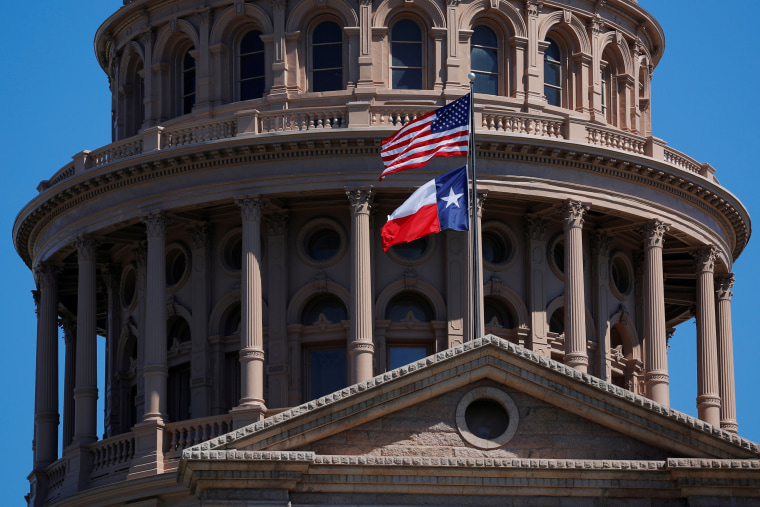 Image: FILE PHOTO - The U.S flag and the Texas State flag fly over the Texas State Capitol in Austin