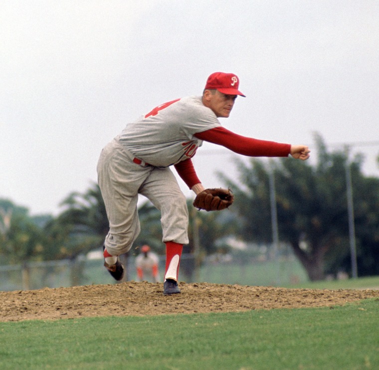 Image: Jim Bunning, number 14 for the Philadelphia Phillies, during a game from his 1964 season. Bunning played for 17 years with 4 different teams. He was 7-time All-Star and was inducted to the Baseball Hall of Fame in 1996.