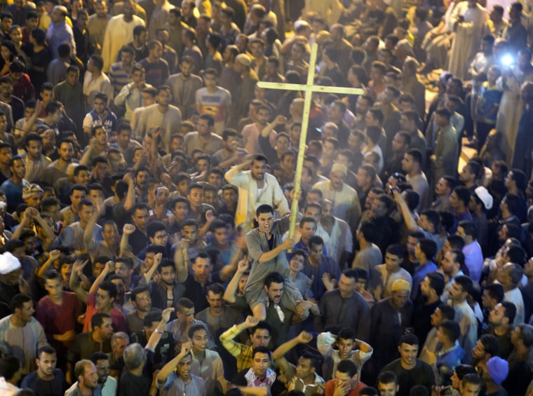Image: Coptic Christians shout after the funeral of some of the victims of the bus attack.