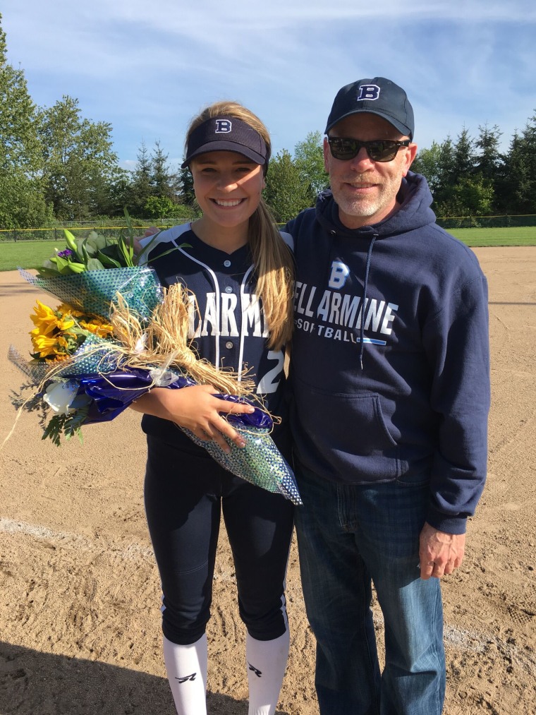 Meg Sullivan with her dad at senior night last month, a celebration for seniors after the last home softball game.
