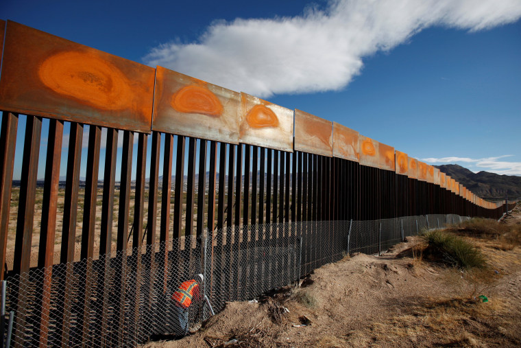 Image: FILE PHOTO: U.S. worker inspects a section of the U.S.-Mexico border wall at Sunland Park, U.S. opposite the Mexican border city of Ciudad Juarez