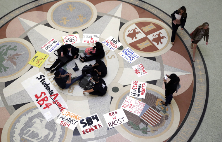 In this April 26, 2017, file photo, students gather in the Rotunda at the Texas Capitol to oppose SB4, an anti-"sanctuary cities" bill that already cleared the Texas Senate and seeks to jail sheriffs and other officials who refuse to help enforce federal immigration law, as the Texas House prepares to debate the bill in Austin, Texas.