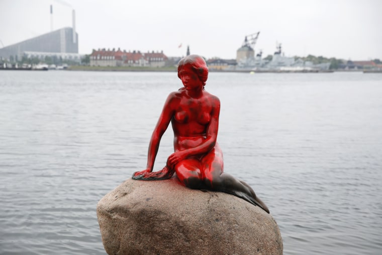 Image: Red paint covers  the vandalized tourist attraction The Little Mermaid in Copenhagen