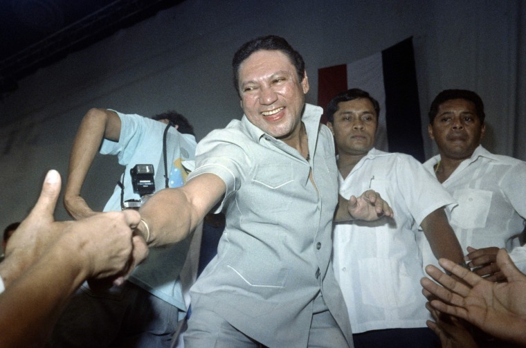 Image:  General Manuel Antonio Noriega reaching down to shake the hands of followers who attended Noriega's birthday party