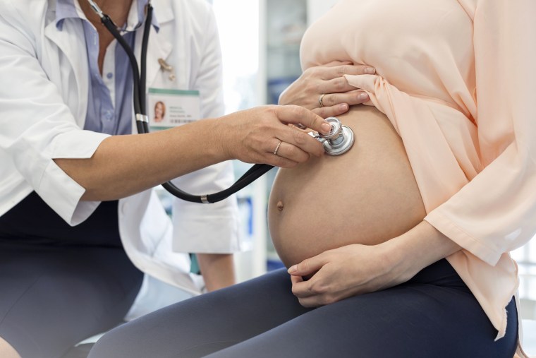 Image: Doctor Using Stethoscope On Pregnant Patient