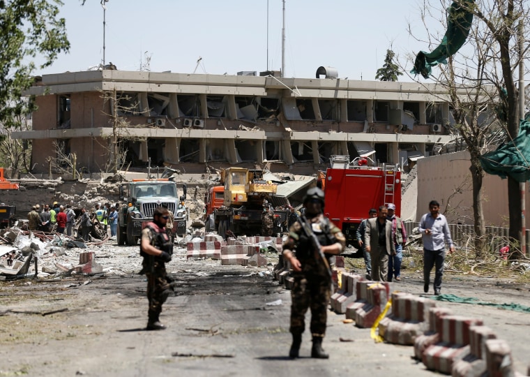 Image: Afghan officials inspect outside the German embassy after a blast in Kabul, Afghanistan