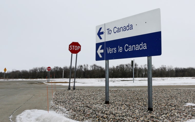 Image:: A highway traffic sign on the U.S side of the border pointing to the direction of Canada, at Emerson, Manitoba, Canada