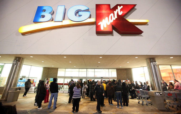 Image: Shoppers wait outside a Kmart in Griffith