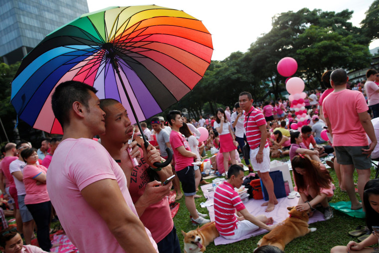 Image: FILE PHOTO: Participants dressed in pink enjoy a picnic before taking part in the forming of a giant pink dot at the Speakers' Corner in Hong Lim Park