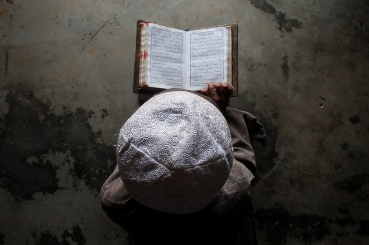 Image: A Muslim boy learns to read the Koran at a madrassa, or religious school, during the holy month of Ramadan, on the outskirts of Agartala