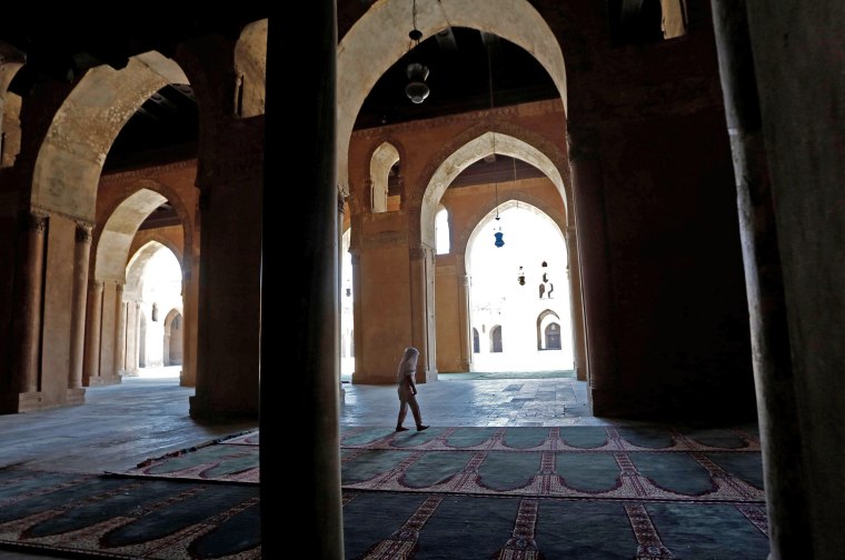 Image: A girl walks inside Ibn Tulun Mosque on the first Friday of the holy month of Ramadan in old Cairo