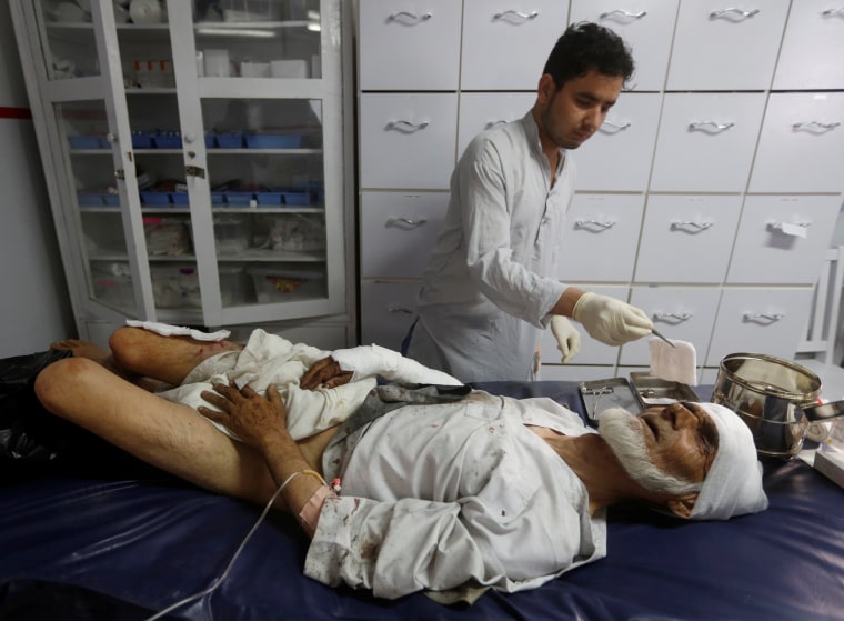 Image: An injured man receives treatment at a hospital after the blasts.