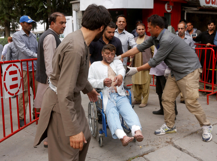 Image: An injured man leaves the hospital after receiving treatment.
