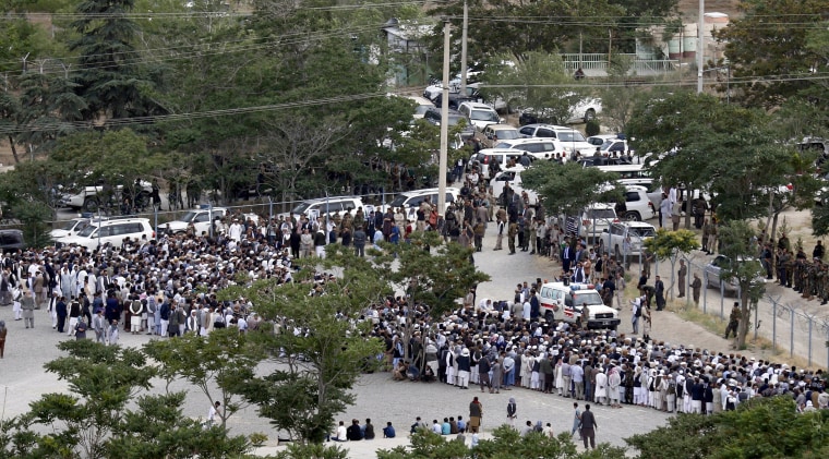 Image: People gathered for funeral services, before any explosions erupt.