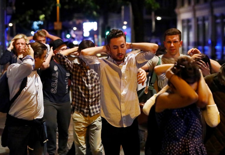 Image: People leave the area with their hands up after an incident near London Bridge in London, Britain, in the early hours of June 4, 2017.