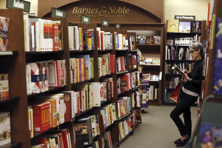 Image: File of a woman reading a book at a Barnes & Noble bookstore in Pasadena, California