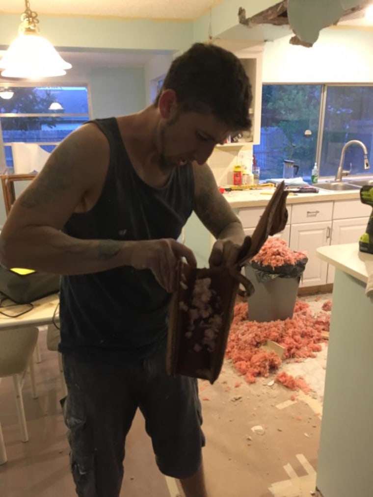 Bobby Kapsidis of Sierra Vista, Ariz., doing renovations on his mother's home in Holiday, Florida. He found a purse made out of alligator in the ceiling.